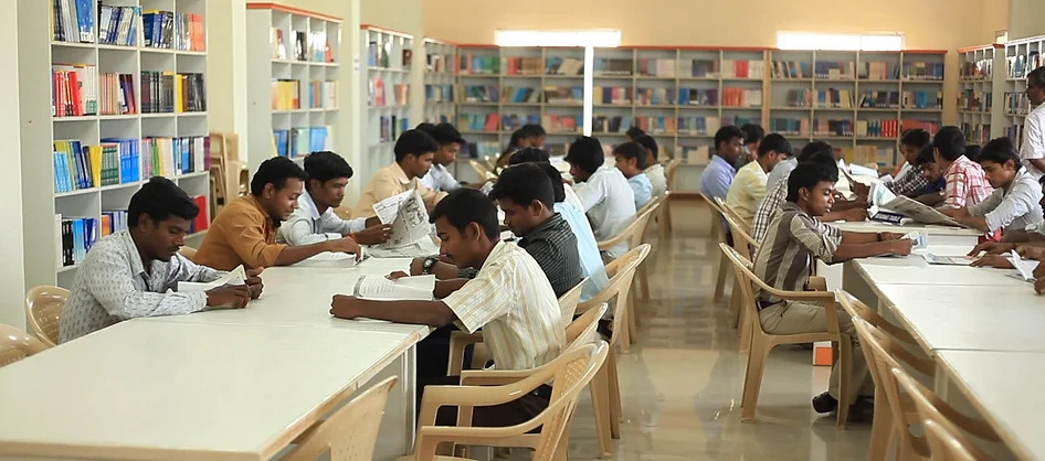 Students reading at long tables in an AKT library